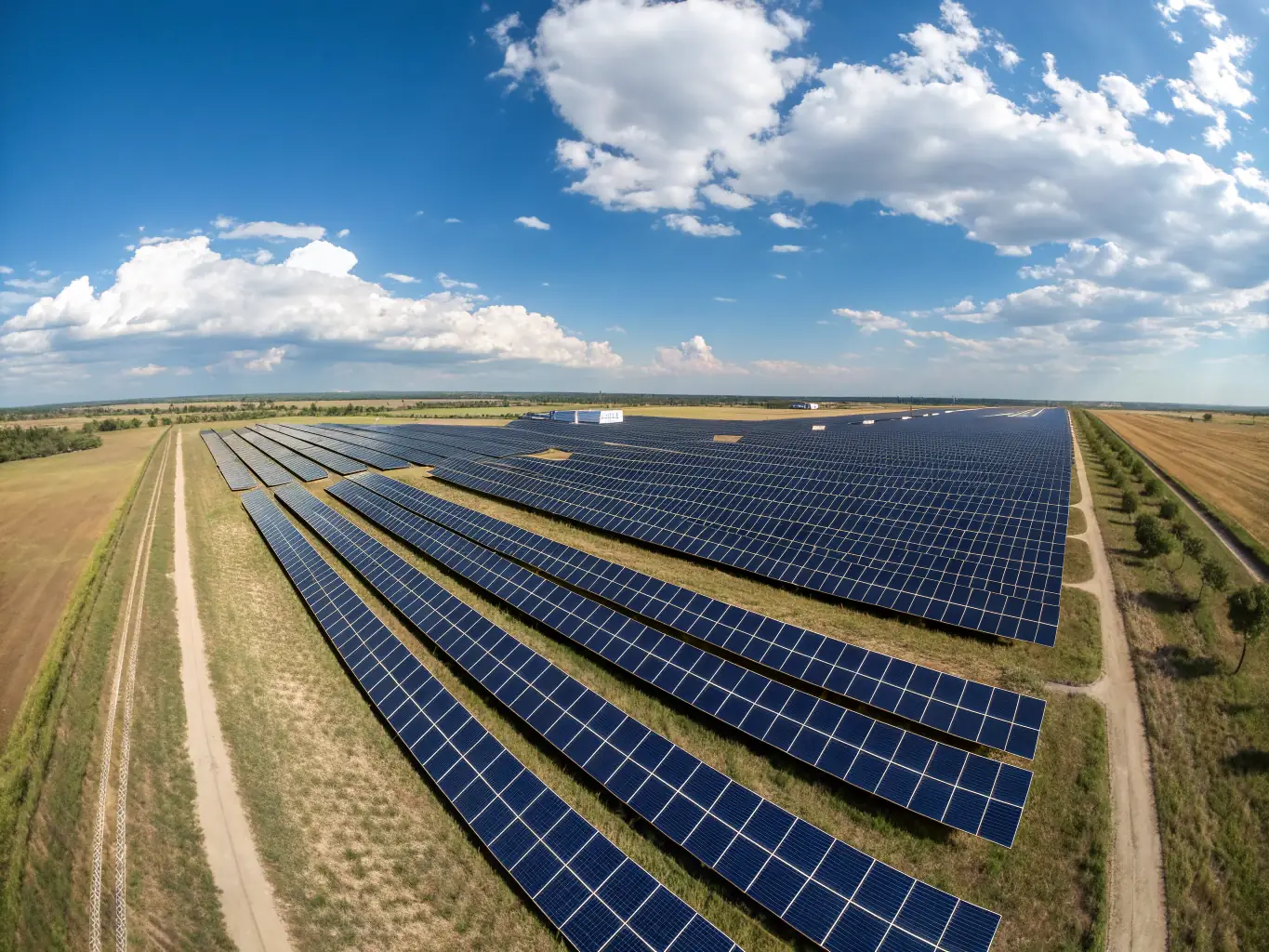 An aerial view of a large-scale industrial solar park, highlighting the scale and efficiency of Tecnogreen Srls's industrial solar installations.